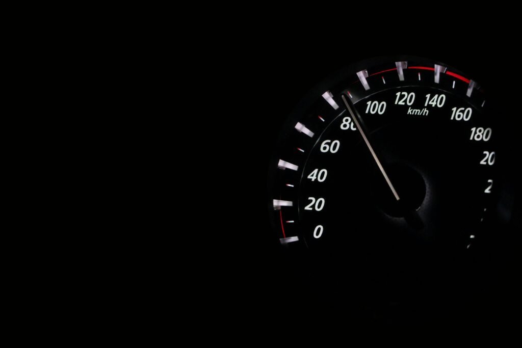 pexels-photo-248747-248747-1 Speedometer reading showing speed in km/h on a dark background.